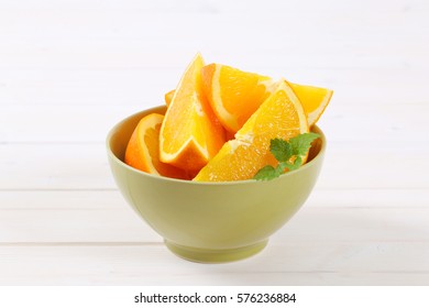 Slices Of Fresh Orange In Green Bowl