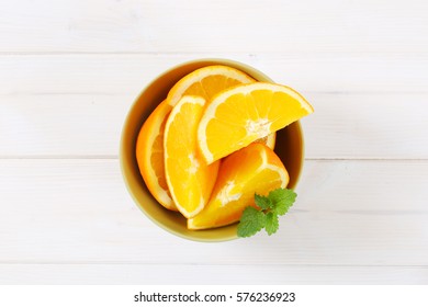 Slices Of Fresh Orange In Green Bowl