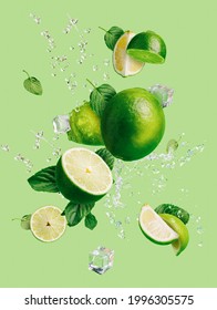 Slices of fresh and ripe lime with ice cubes, splashing water and mint leaves thrown in the air, flying and levitating on a bright green background. Creative food concept. Summer citrus fruit. - Shutterstock ID 1996305575