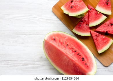 Slices of fresh watermelon on bamboo board, from above. Top view. Copy space. - Shutterstock ID 1129654364