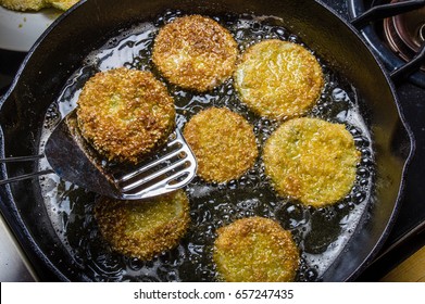 Slices Of Green Tomato Being Fried To Make Fried Green Tomatoes