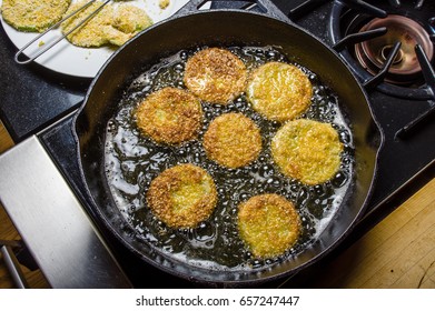 Slices Of Green Tomato Being Fried To Make Fried Green Tomatoes