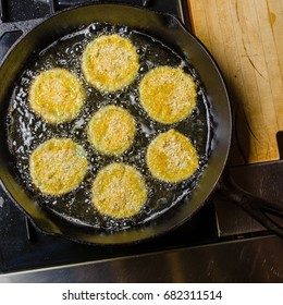 Slices Of Green Tomato Being Fried To Make Fried Green Tomatoes