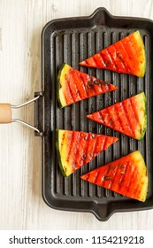 Slices Of Grilled Watermelon In Grilling Pan On A White Wooden Table, Overhead View. Healthy Summer Fruit. Top View, From Above.