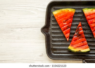 Slices Of Grilled Watermelon In Grilling Pan On A White Wooden Table, Overhead View. Healthy Summer Fruit. Copy Space.