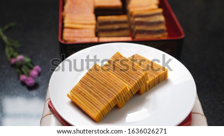 Slices of Indonesian Lapis Cake against dark background. Layered cake. Thousand Layer Cake. In Indonesia known with 'Lapis Legit'. Stock photo © 
