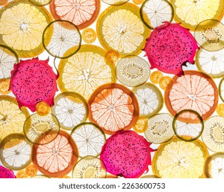 Slices of lemon, orange, kiwi and backlit fruits. Macro 