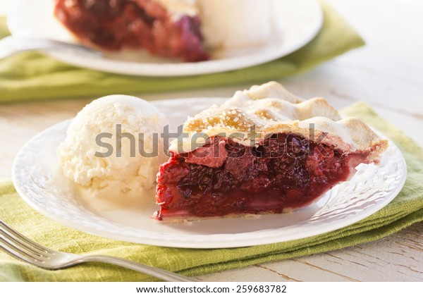 Slices of Mixed Berry\
Pie with Ice Cream