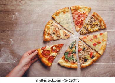 slices of pizza with different toppings on a wooden background