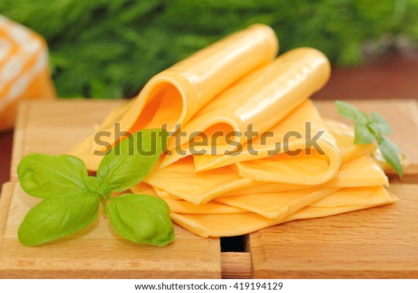 Slices of processed\
cheese with greens