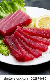 Slices Of Raw Bluefin Tuna  Sashimi On White Dish On Wood Background