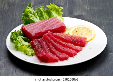 Slices Of Raw Bluefin Tuna  Sashimi On White Dish On Wood Background