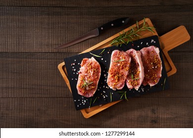 Slices Of A Raw Pork Fillet On A Cutting Board