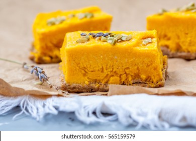 Slices of raw vegan pumpkin cheesecake. Love for a healthy raw desserts concept.