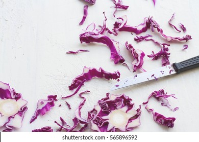 Slices of red cabbage or purple cabbage and knife on rustic  white wooden board, a preparation for cooking, healthy vegetable, high vitamin K, dietary fiber, reduce chances of cancer - Powered by Shutterstock