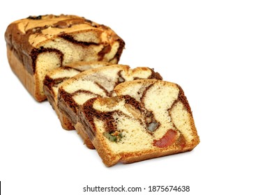 Slices of Romanian sponge cake with cocoa, turkish delight and raisins on white backgrpind