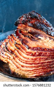 Slices Of Rustic Holiday Honey Glazed Baked Ham In Cast Iron 