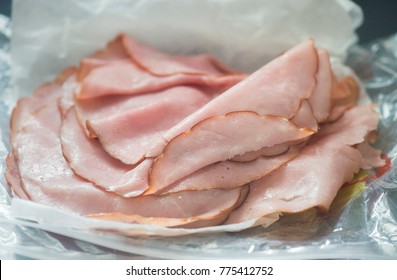 Slices Of Sandwich Ham Is Shown On Wax Paper