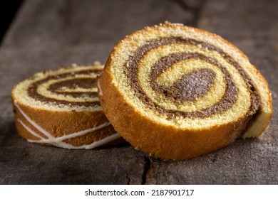 Slices Of Sponge Cake Roll Over Wooden Background