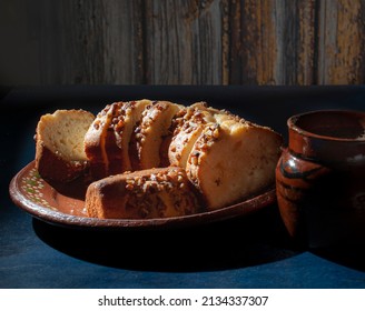 Slices Of Sweet Bread With Pieces Of Walnuts On Top, Over A Mud Or Clay Mexican Plate And A Blue Surface Table, Overhead, Top View Flat Lay Horizontal Macro Photography.