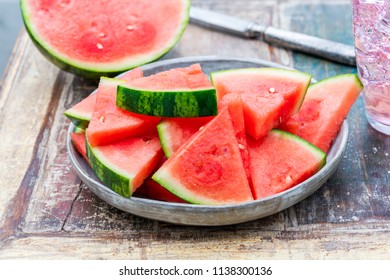 Slices of sweet, refreshing watermelon on a garden table. Summer outdoor eating. - Powered by Shutterstock