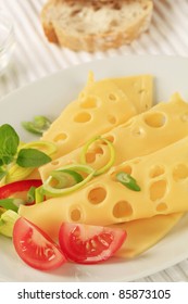 Slices Of Swiss Cheese Sprinkled With Spring Onion 
