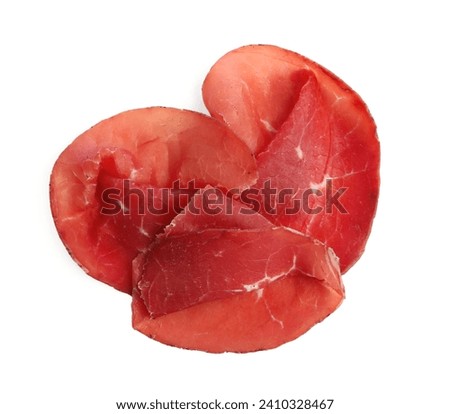 Slices of tasty bresaola isolated on white, top view