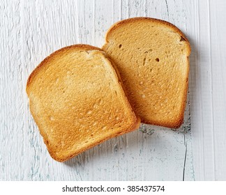 Slices of toast bread on wooden table, top view