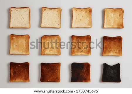 Similar – Image, Stock Photo Toasted toast bread in toaster on pink background