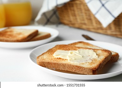 Slices Of Toasted Bread With Butter On White Table