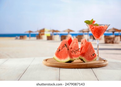 Slices of watermelon and small coctail with frsh mint leaf in glass on white table top and blur background of exotic sandy beach and blue sky. Empty copy space for products and food. - Powered by Shutterstock