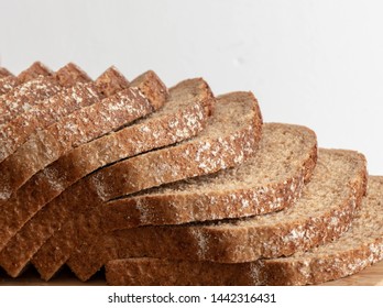 Slices of whole grain bread on white background background. homemade slide bread on the wooden broad. Sliced Wheat Bread on white background
