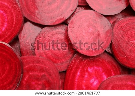 Slices of young beets as background, top view