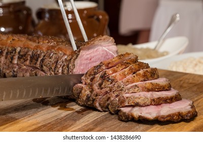 Slicing beef tenderloin on a cutting board