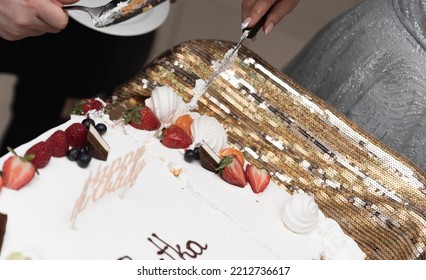 Slicing A Birthday Cake. The Cake In Close-up. Knife In A Woman's Hand.