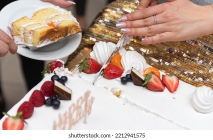 Slicing A Birthday Cake. The Cake In Close-up. Knife In A Woman's Hand.