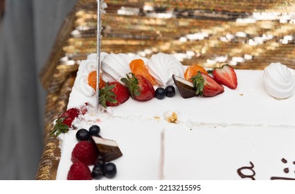 Slicing A Birthday Cake. The Cake In Close-up. Knife In A Woman's Hand.