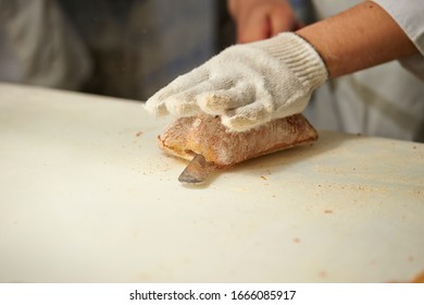 Slicing bread half with knife