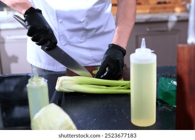 Slicing celery into pieces on wooden board. Healthy organic vegetables. Cook's hands. Concept of cooking. Healthy eating. - Powered by Shutterstock