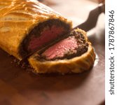 Slicing of filet of beef in puff pastry