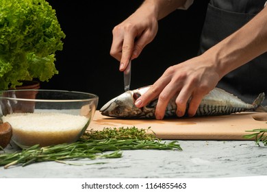 Slicing fish by the chef on a black background - Powered by Shutterstock