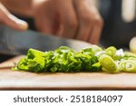 slicing fresh green onions with chef