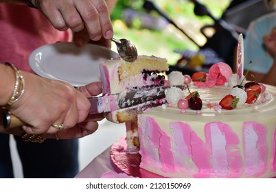 Slicing A Pink Birthday Cake Using Knife By Hand