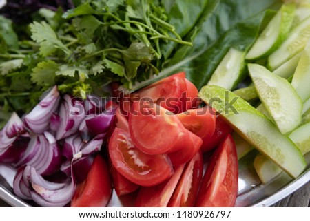 slicing vegetables from cucumbers, tomatoes, onions and herbs