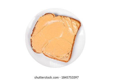 A Slide Of Bread With Peanutbutter On A Plate Isolated On White.