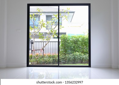 Slide Glass Door With Small Garden Landscaping In Front Of A New House