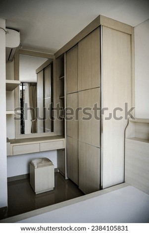 sliding door wardrobe adjacent to the dressing table, placed in the corner of the room. 