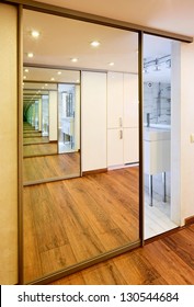 Sliding-door mirror wardrobe in modern hall interior with infinityreflections