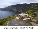 Slieve League cliff landscape in County Donegal, Ireland. Picnic table next to a hiking trail.