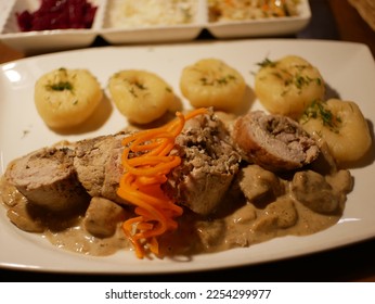 Slightly blurred polish pork roulade, filled with mushrrom and bacon called rolada Śląska, served with dumpling called szare kluski. Krakow, Poland.